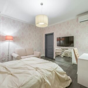 A stylish modern bedroom featuring a comfortable bed, sleek decor, and a wall-mounted TV for a relaxing ambiance.