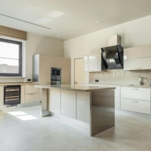 A bright, spacious kitchen featuring minimalist design and modern appliances.