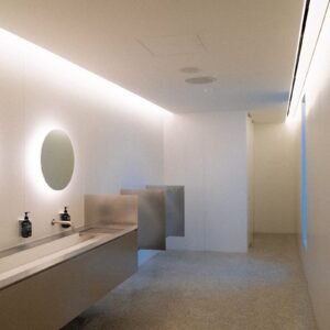 A bathroom with two sinks and a mirror